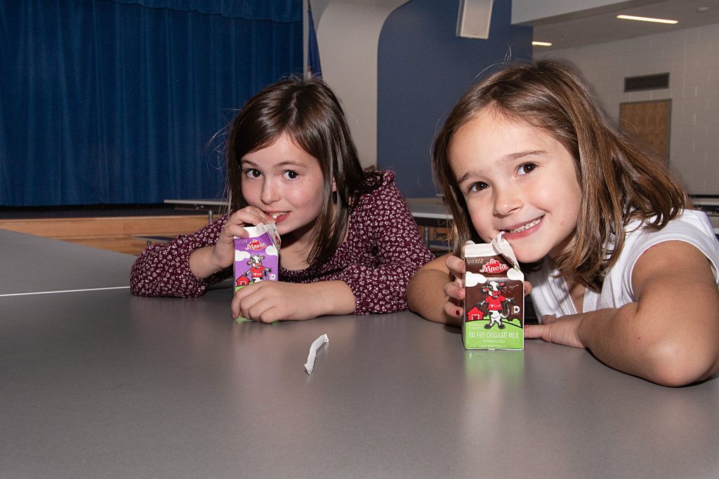 Two girls drink from Maola cartons